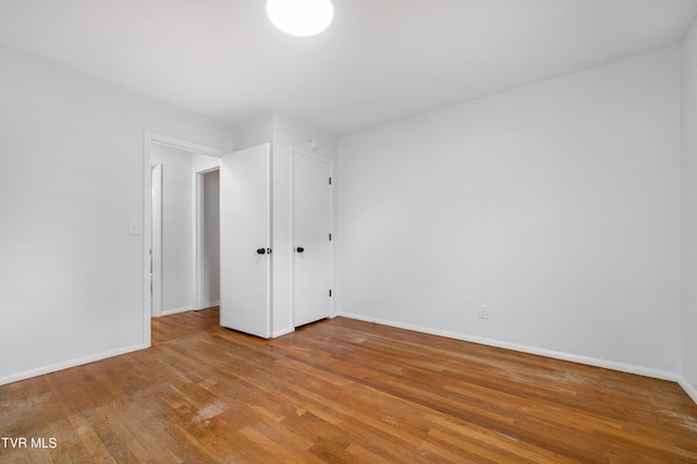 unfurnished bedroom featuring hardwood / wood-style flooring