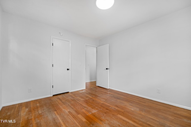 spare room with light hardwood / wood-style flooring