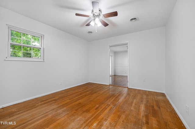 empty room with hardwood / wood-style flooring and ceiling fan