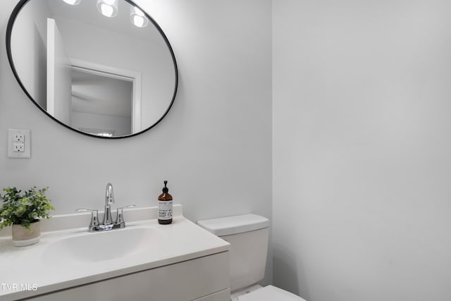 bathroom featuring toilet and vanity