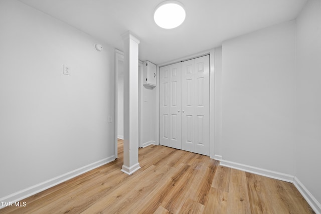 unfurnished bedroom featuring light wood-type flooring and a closet