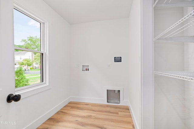 clothes washing area with laundry area, washer hookup, baseboards, light wood-style floors, and electric dryer hookup