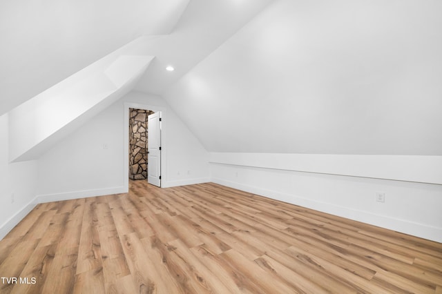 bonus room with vaulted ceiling and light hardwood / wood-style flooring