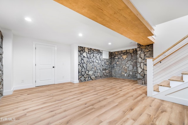 finished below grade area with recessed lighting, stairway, baseboards, and wood finished floors