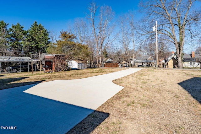 view of yard with a storage unit and an outbuilding