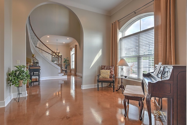 sitting room featuring crown molding and an inviting chandelier