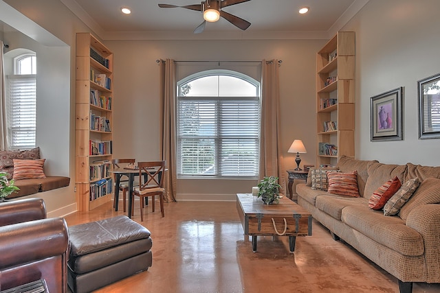 living room featuring ceiling fan, ornamental molding, and built in shelves