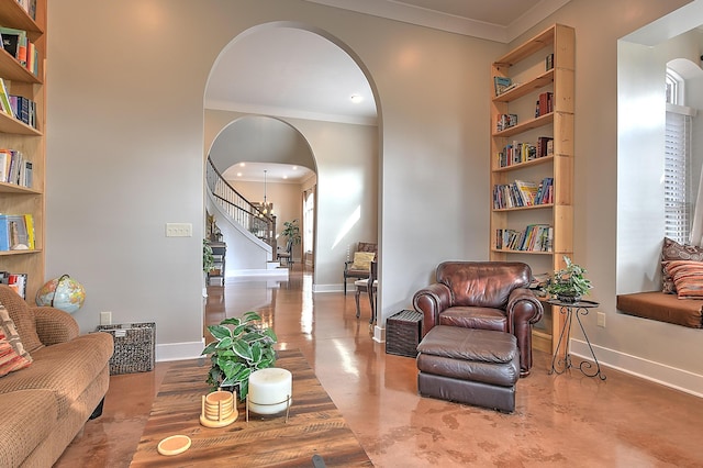 living room with a wealth of natural light, crown molding, and built in features