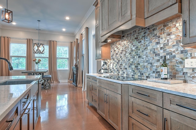 kitchen with black electric stovetop, backsplash, light stone counters, and decorative light fixtures