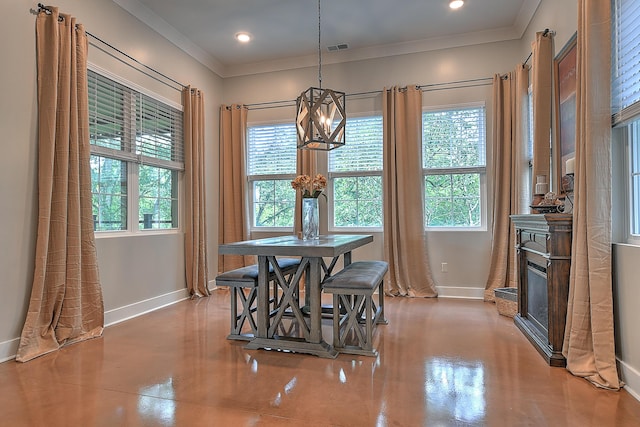 dining space with crown molding, plenty of natural light, and a notable chandelier