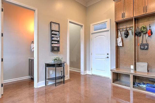 mudroom featuring ornamental molding and concrete flooring