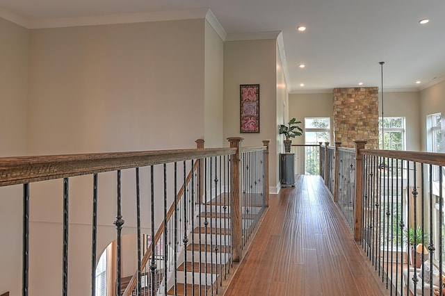 hall with ornamental molding and hardwood / wood-style flooring