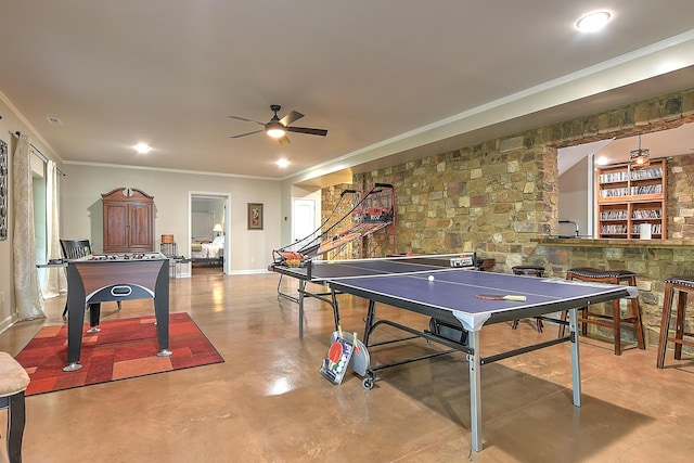 game room featuring ceiling fan, crown molding, and concrete floors