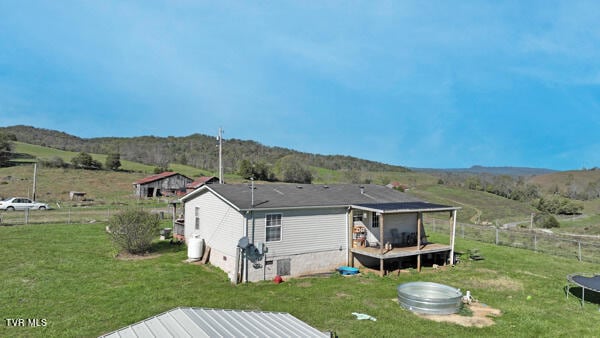 141 Pumplog Holw, Castlewood, VA 24224 - back of house featuring a trampoline, a wooden deck, and a lawn