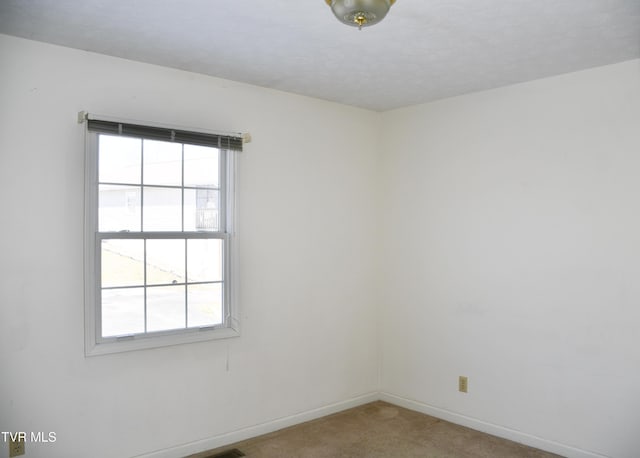 unfurnished room featuring carpet flooring