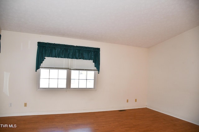 spare room featuring hardwood / wood-style floors