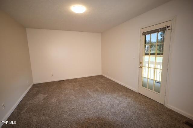 723 Teasel Dr Unit 00, Kingsport, TN 37660 - empty room featuring baseboards, dark colored carpet, and visible vents