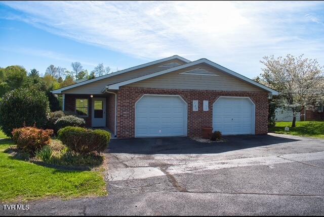 723 Teasel Dr Unit 00, Kingsport, TN 37660 - view of property exterior featuring driveway, brick siding, and a garage