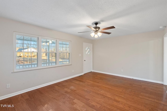 unfurnished room featuring ceiling fan, wood-type flooring, and a textured ceiling