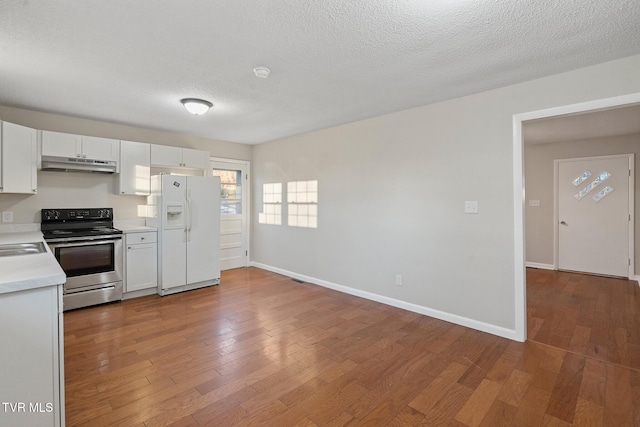 kitchen with white fridge with ice dispenser, a textured ceiling, white cabinetry, wood-type flooring, and stainless steel electric range