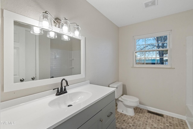 bathroom with toilet, walk in shower, and vanity