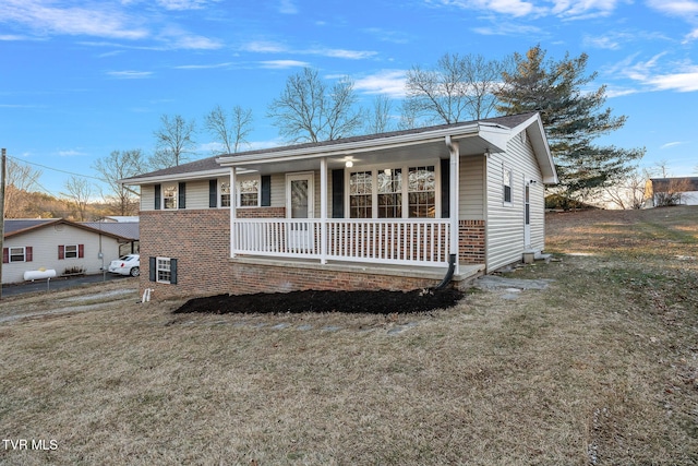 view of front of home featuring covered porch and a front lawn