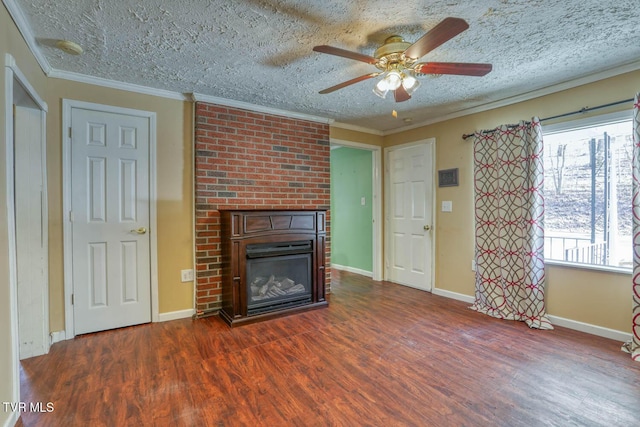 unfurnished living room featuring crown molding, ceiling fan, dark hardwood / wood-style flooring, a fireplace, and a textured ceiling