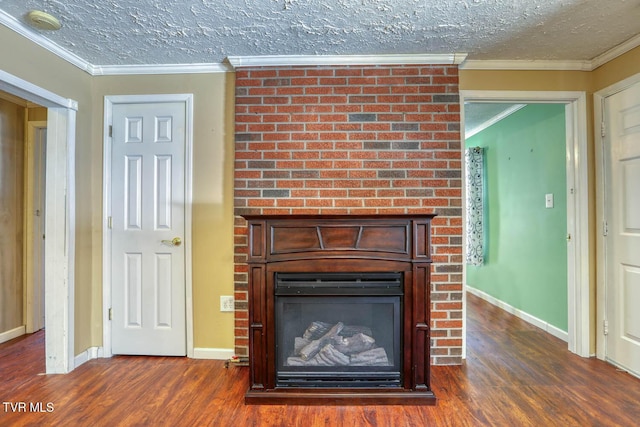 interior details featuring hardwood / wood-style flooring, a brick fireplace, ornamental molding, and a textured ceiling