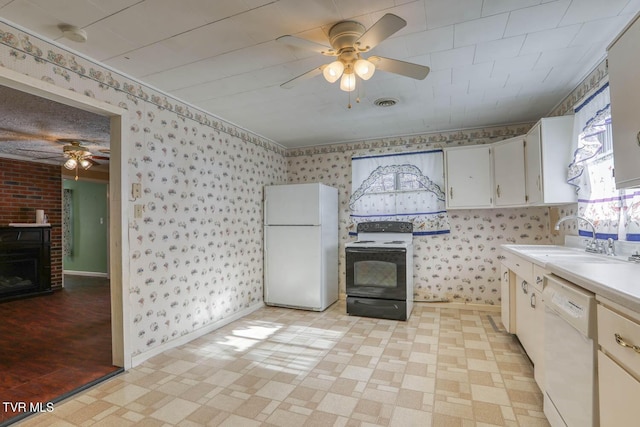 kitchen featuring sink, white appliances, white cabinetry, and ceiling fan