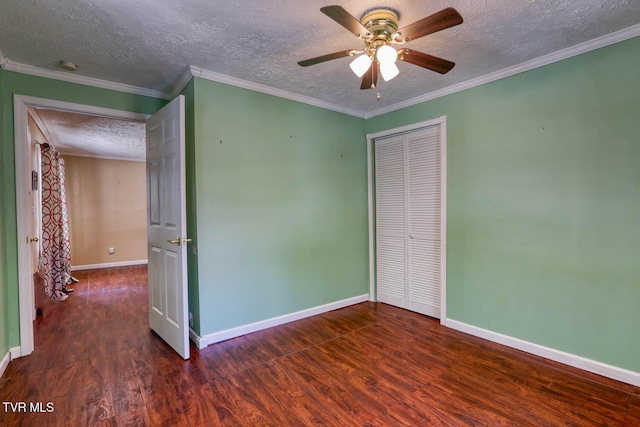 unfurnished bedroom with crown molding, a textured ceiling, a closet, ceiling fan, and dark hardwood / wood-style floors