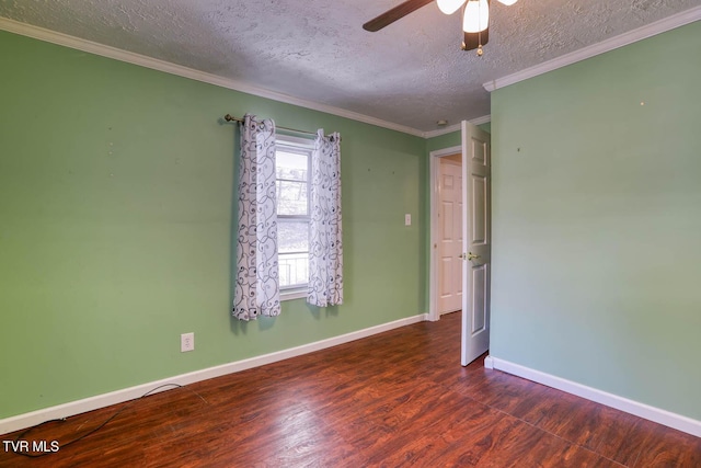 empty room featuring dark hardwood / wood-style flooring, a textured ceiling, ceiling fan, and ornamental molding