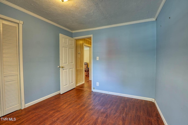 unfurnished bedroom with a textured ceiling, dark hardwood / wood-style floors, a closet, and crown molding