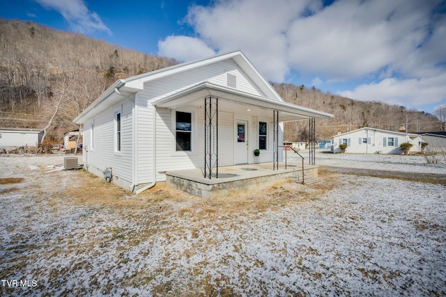 bungalow-style home featuring covered porch and central air condition unit