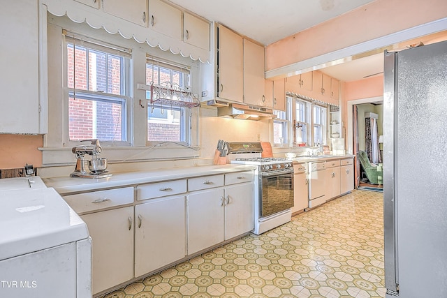 kitchen featuring white cabinetry and white appliances