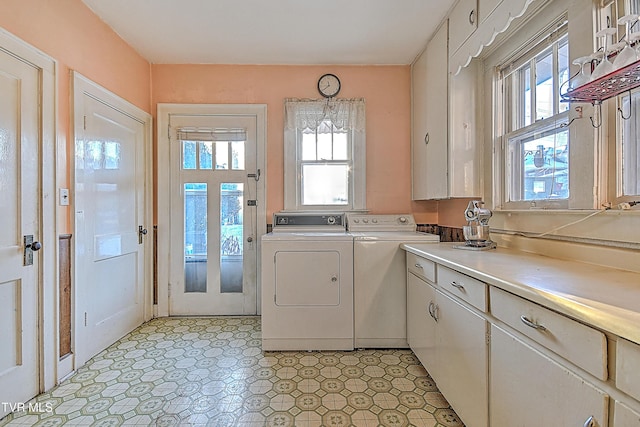 laundry area with cabinets and washing machine and dryer