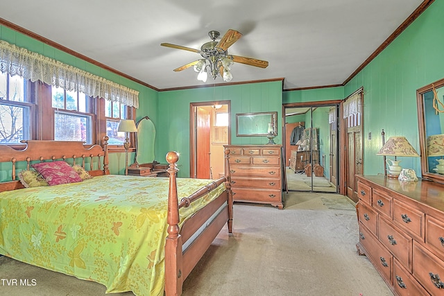 bedroom featuring a closet, ceiling fan, ornamental molding, and light carpet