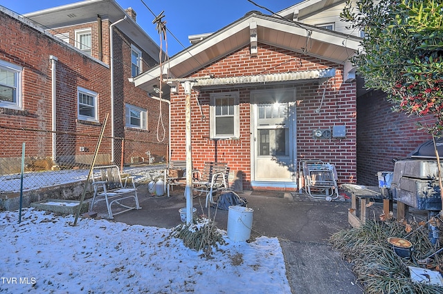 view of snow covered back of property