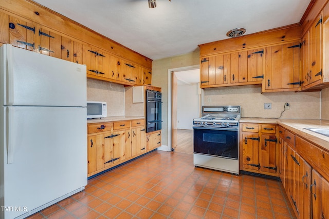 kitchen featuring white appliances, visible vents, light countertops, a warming drawer, and tasteful backsplash