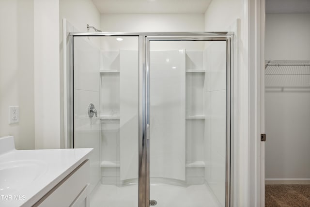 bathroom featuring vanity and an enclosed shower