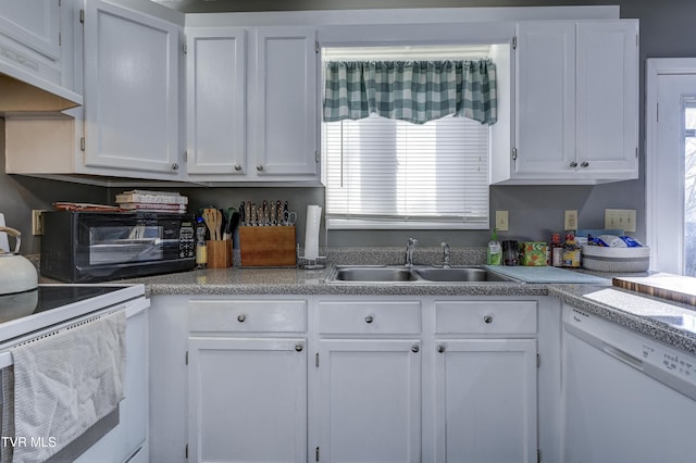 kitchen featuring white appliances, sink, and white cabinets