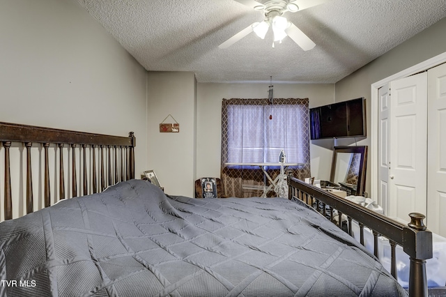 bedroom with ceiling fan, a closet, and a textured ceiling