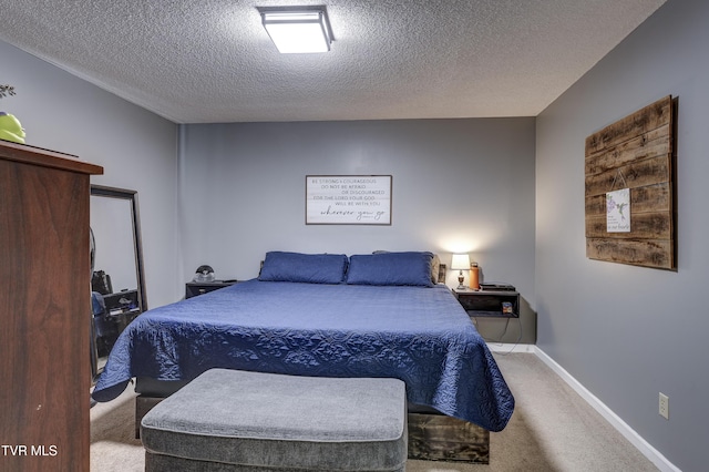 bedroom featuring carpet floors and a textured ceiling