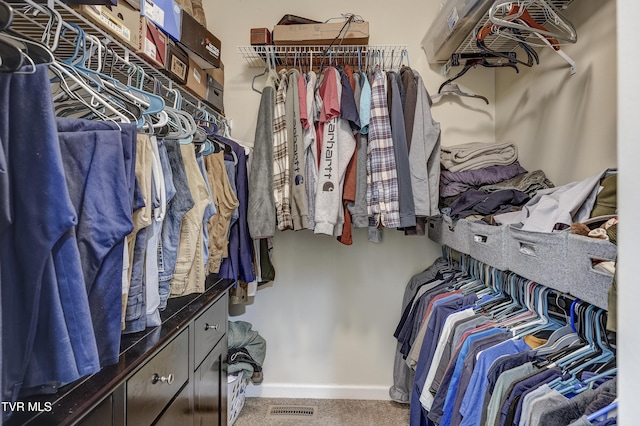 walk in closet featuring carpet flooring