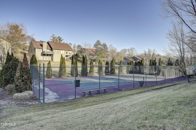 view of sport court featuring a lawn