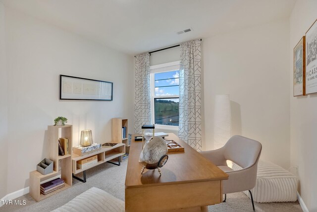 carpeted home office with visible vents and baseboards