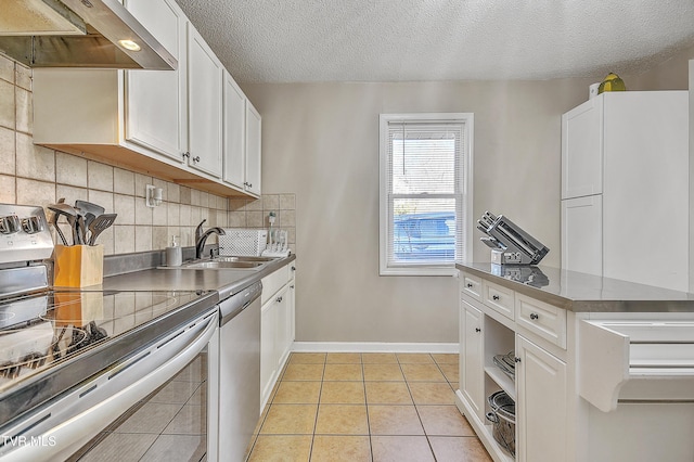 kitchen with white cabinetry, tasteful backsplash, range hood, and appliances with stainless steel finishes