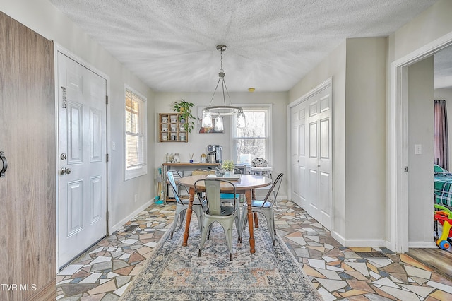 dining area featuring a textured ceiling