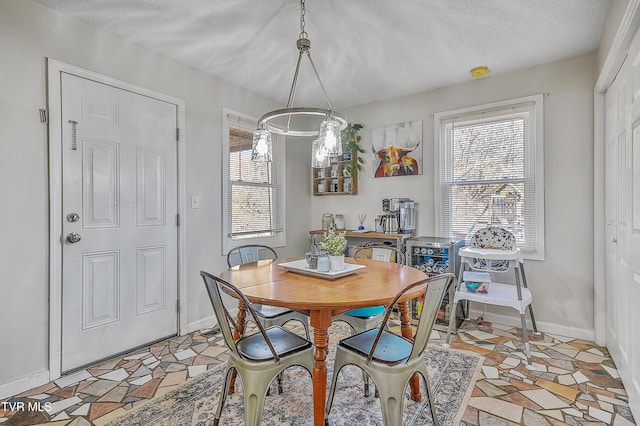 dining area with a textured ceiling