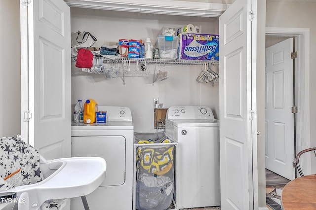 laundry area with washing machine and clothes dryer and sink