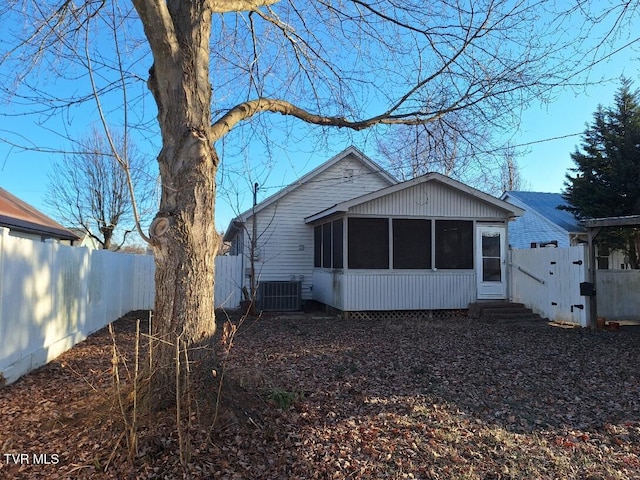 back of property featuring a sunroom and central air condition unit